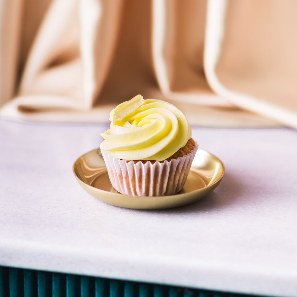 Indulge in a zesty and refreshing lemon cupcake, with its bright and tangy flavor and a dollop of creamy frosting. Pair it perfectly with a crisp and refreshing Brut Cava, with its subtle fruit notes that complement the cupcake&
