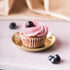 Enjoy a burst of fruity flavor with a delightful blueberry cupcake, topped with creamy frosting and a juicy blueberry. Pair it perfectly with a crisp and refreshing Brut Cava, with its bright fruit notes that complement the cupcake&