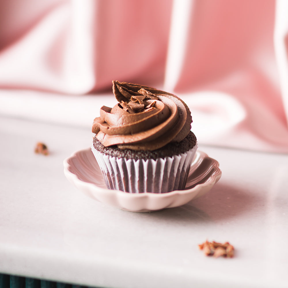 Satisfy your chocolate cravings with a rich and indulgent chocolate cupcake, topped with creamy frosting and a sprinkle of chocolate shavings. Pair it perfectly with a crisp and elegant Brut Rose Cava, with its bright fruit notes that complement the chocolate&
