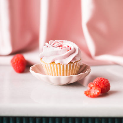 Indulge in a delightful raspberry cupcake, with its sweet and tangy flavor and a dollop of creamy frosting. Pair it perfectly with a crisp and refreshing Brut Cava, with its bright fruit notes that complement the cupcake&